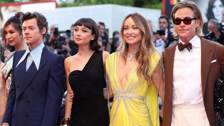 Chris Pine and Harry Styles posing with co-stars