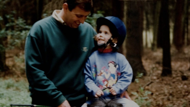 Prince Andrew alongside Princess Eugenie riding a pony 