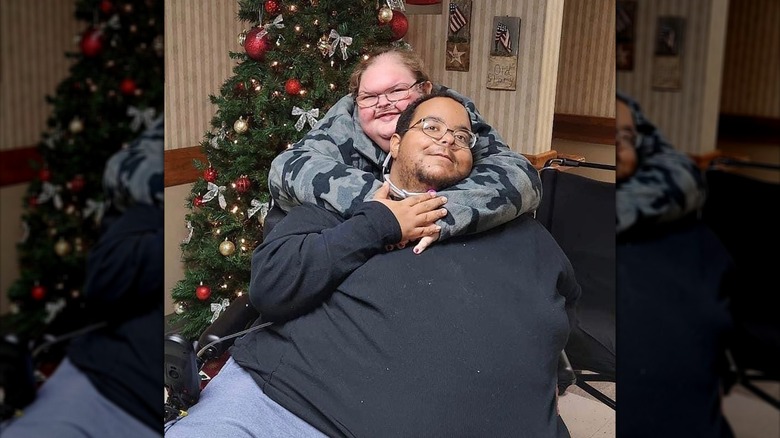 Tammy Slaton and Caleb Willingham posing in front of a Christmas tree