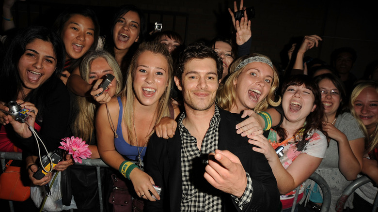 Adam Brody posing with fans during the 2009 Toronto International Film Festival