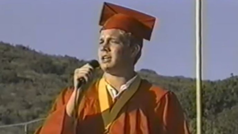 Adam Lambert singing in graduation cap and gown