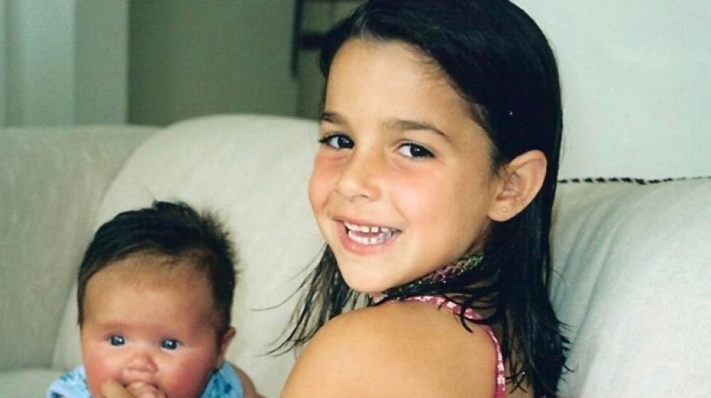 Aly Raisman as a girl with a baby