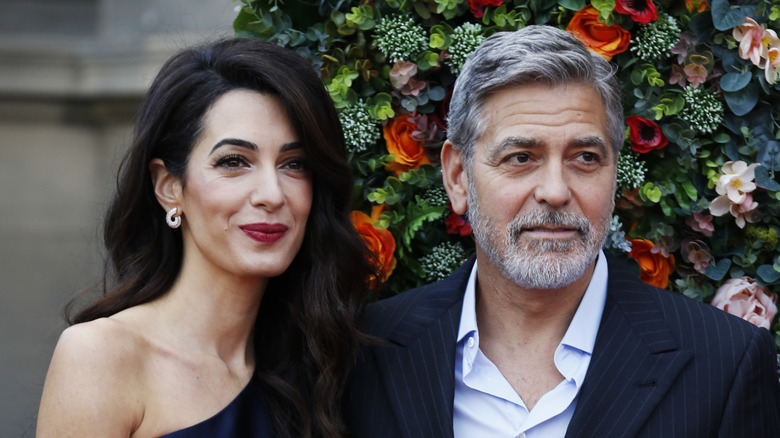 Amal Clooney beside George Clooney