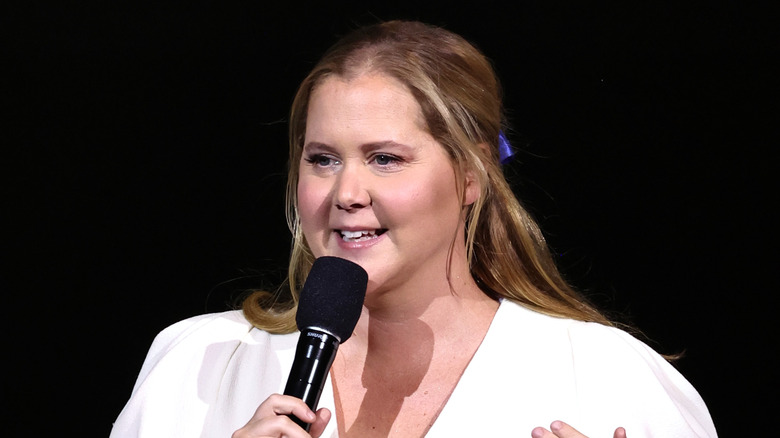 Amy Schumer on stage at a benefit