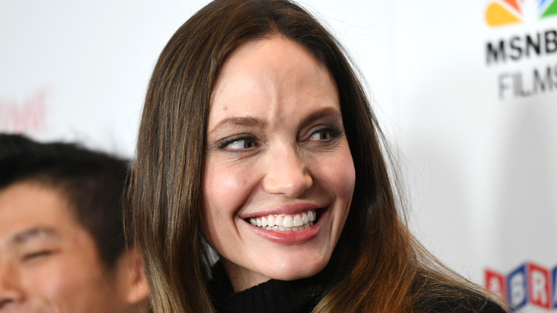 Angelina Jolie smiling over her shoulder