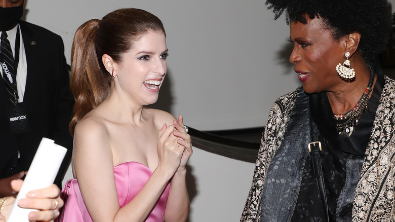 Anna Kendrick laughing in pink dress
