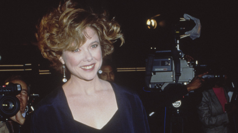 Annette Bening smiling in navy blue dress