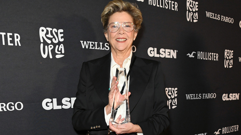 Annette Bening holding an award