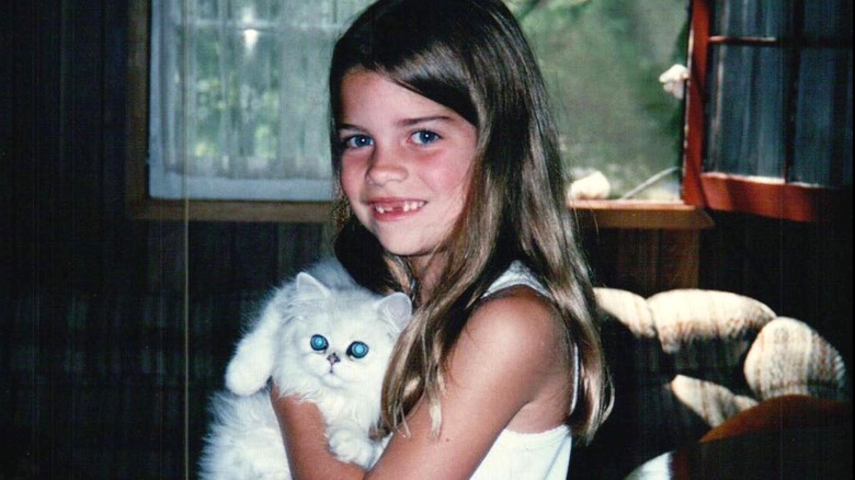 Young Annie Murphy holding cat