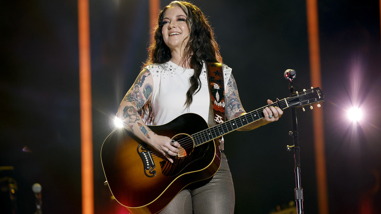 Ashley McBryde playing a guitar