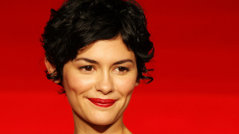 Audrey Tautou against a red background