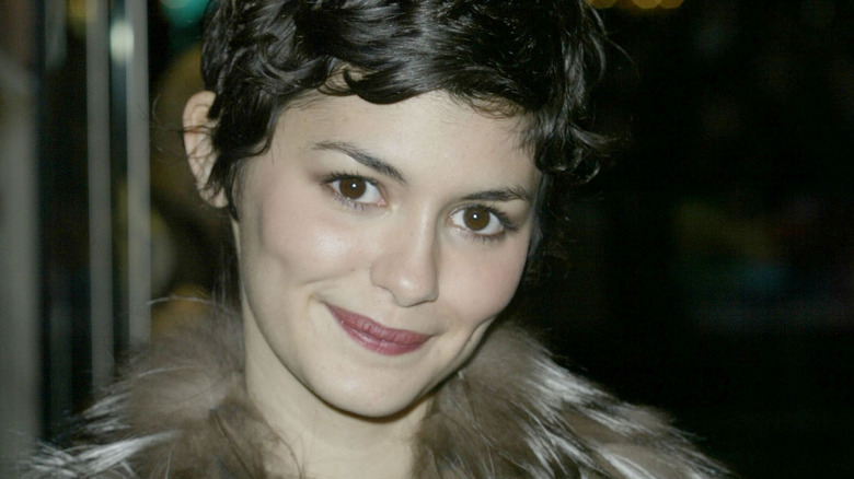 Audrey Tautou smiling in a fur coat