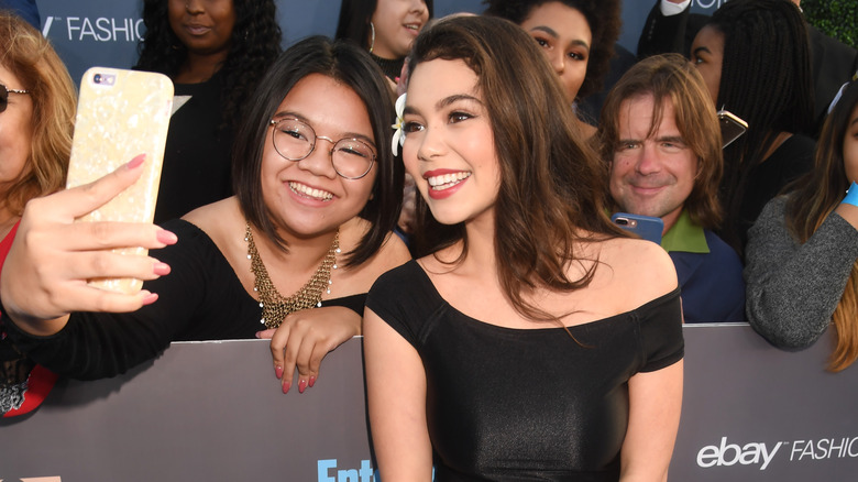 Auli'i Cravalho posing for selfie with fan