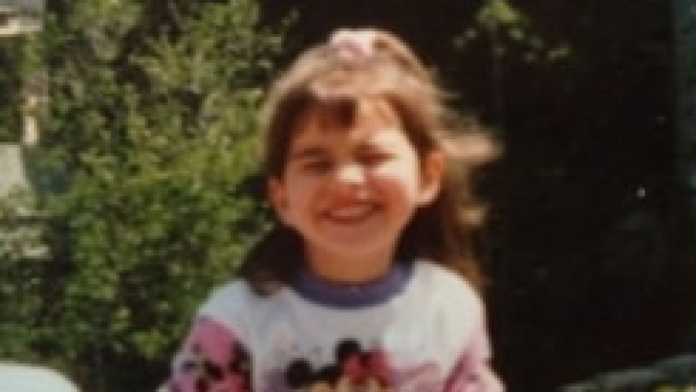 Ashley Iaconetti as a child smiling