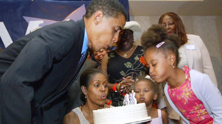 Obama family blowing out candles