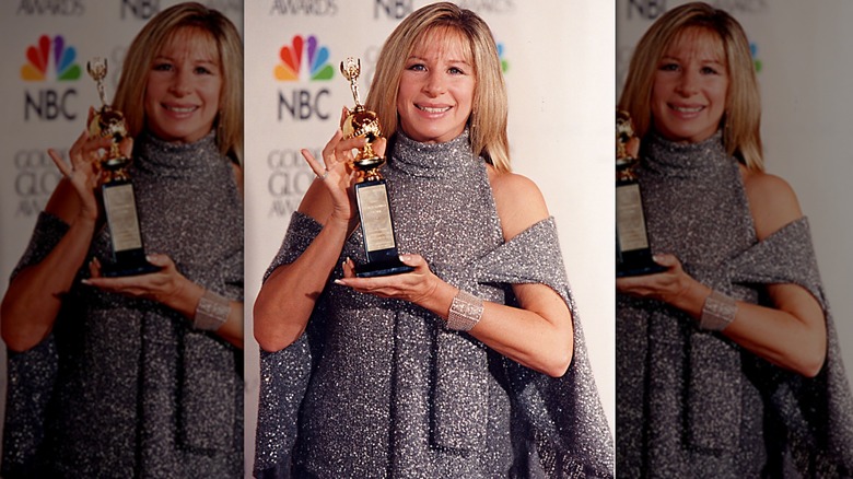 Barbra Streisand holding award