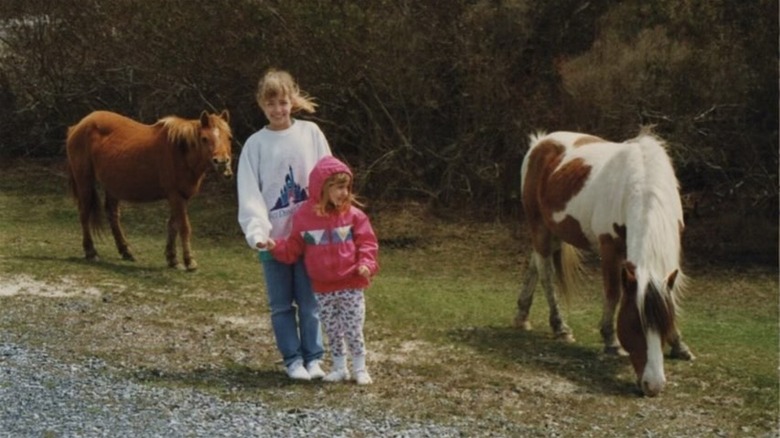 Beth Behrs, her little sister, and two horses