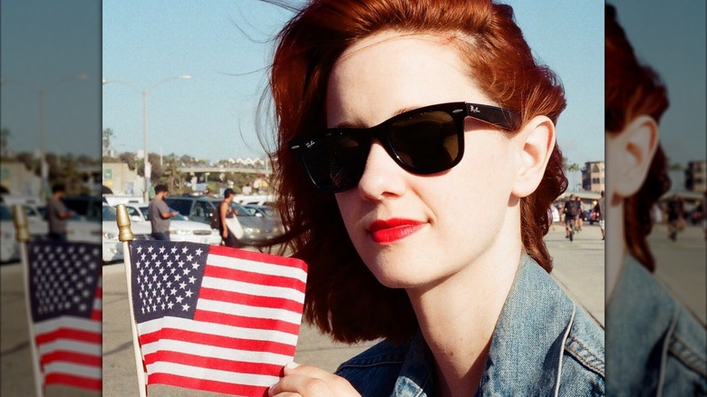 Laura Spencer holding a mini-American flag