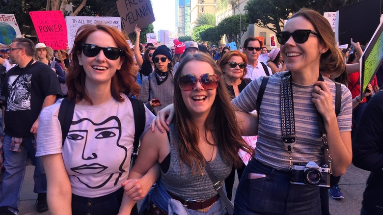 Laura Spencer, Jamie Miller, and Emily Diana Ruth smiling at a Women's March in Los Angeles