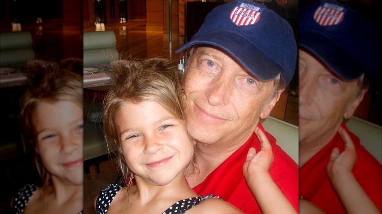 A young Phoebe cuddles up to Bill Gates