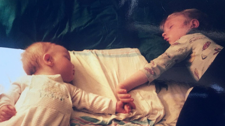 Billie Eilish with her older sibling as a baby