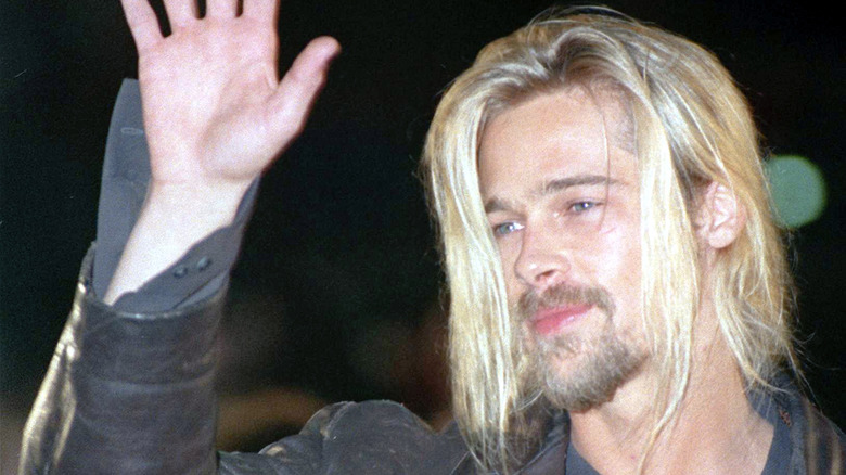 Brad Pitt with long hair, waving