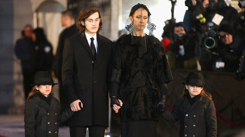 Celine Dion holding kids at husband's funeral