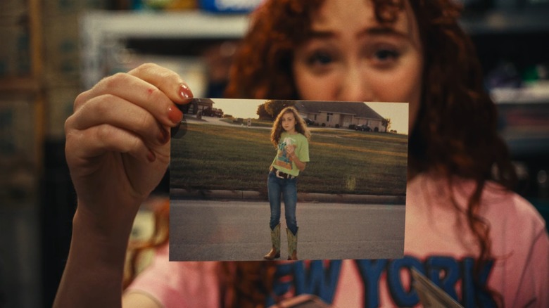 Chappell Roan holding a photo of her younger self