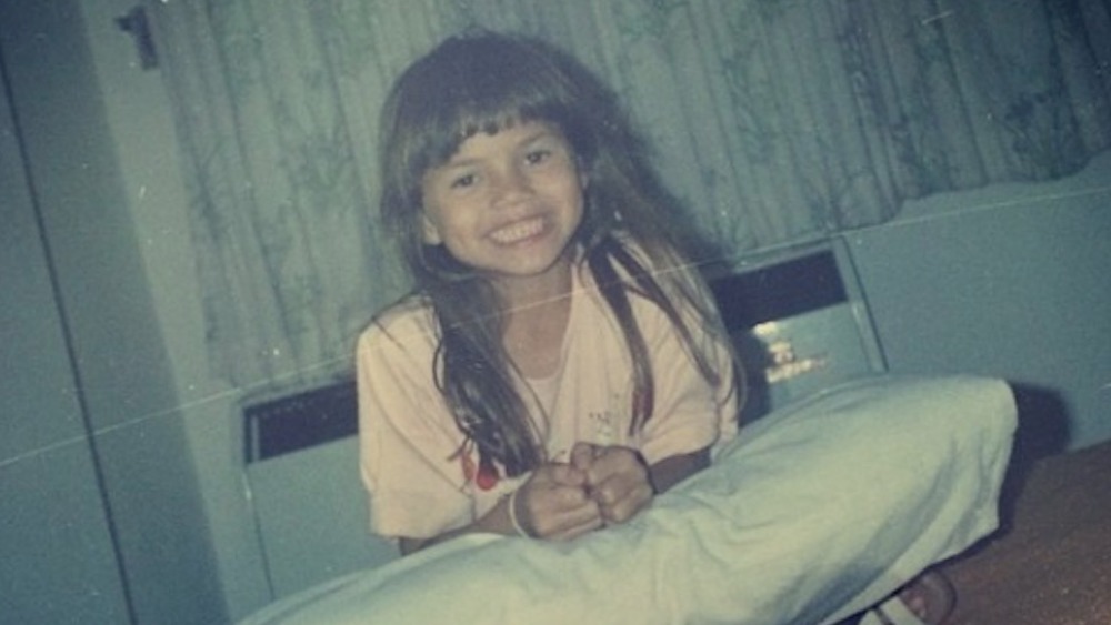 Chrissy Teigen as a young girl, smiling