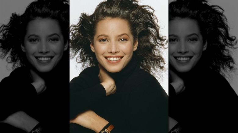 Young Christy Turlington wearing black, smiling