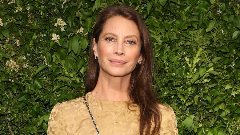 Christy Turlington in beige dress, posing