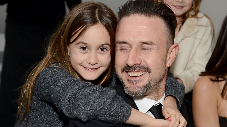 Coco Arquette as a child and David Arquette smiling