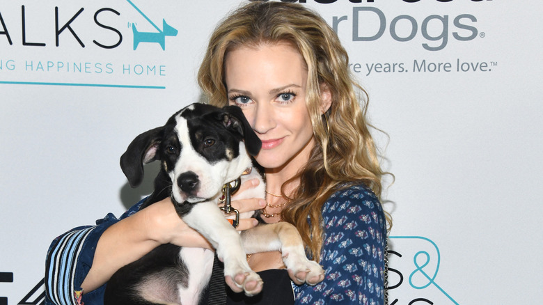 A.J. Cook holding dog at benefit