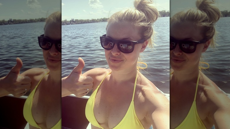 Cristy Lee giving thumbs up in yellow bikini