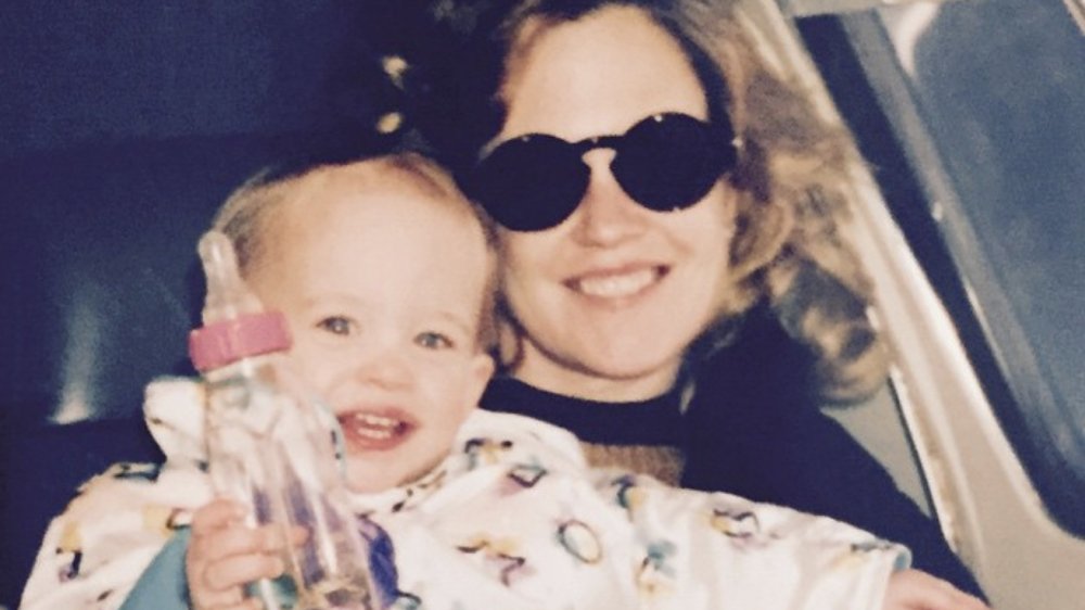 Baby Dakota Johnson sitting on Melanie Griffith's lap