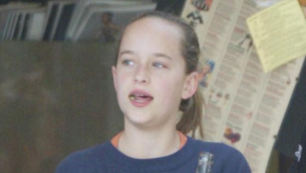 Dakota Johnson as a child chewing gum