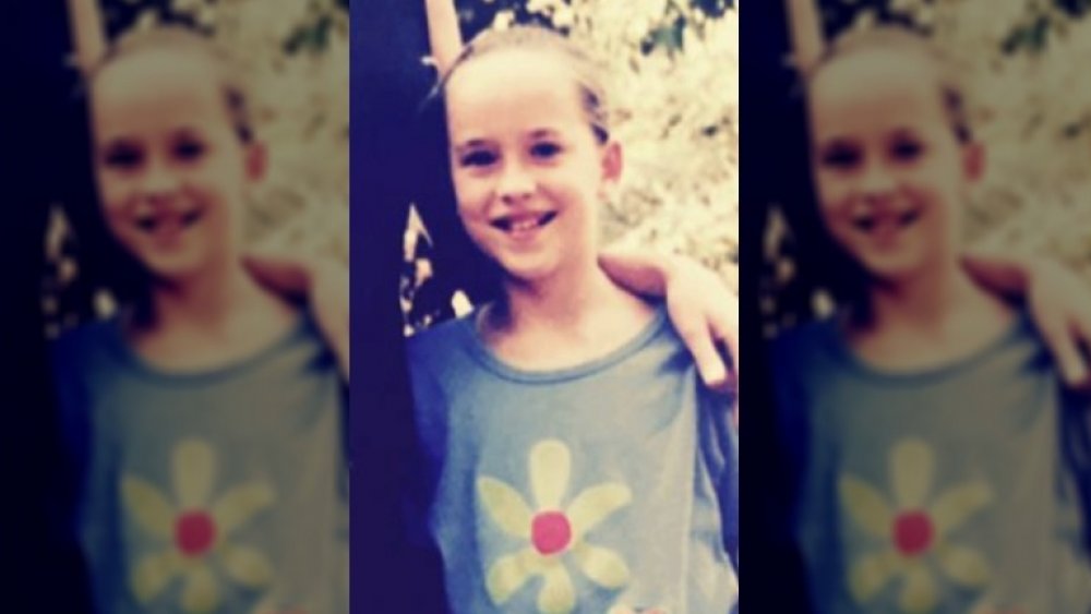Dakota Johnson as a child smiling