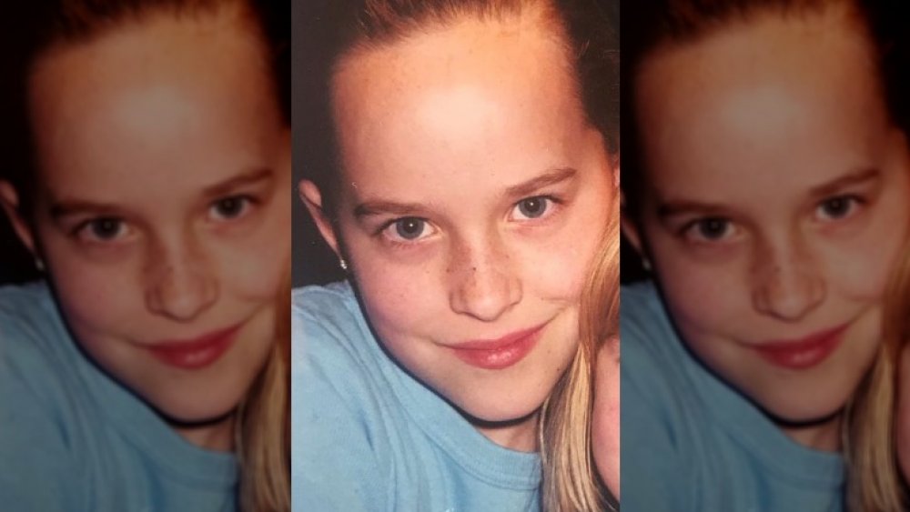 Dakota Johnson as a child smiling