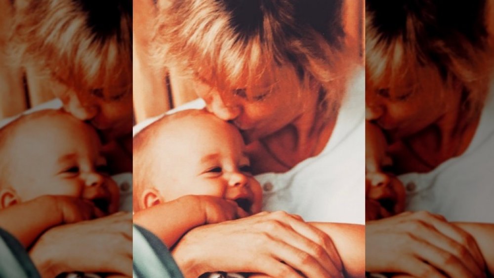 Melanie Griffith holding baby Dakota Johnson