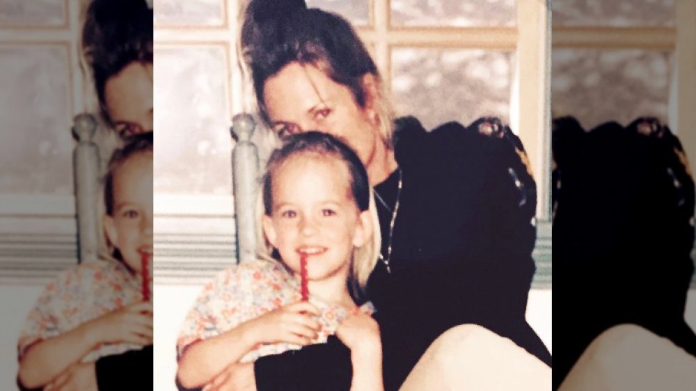 Melanie Griffith posing with young Dakota Johnson