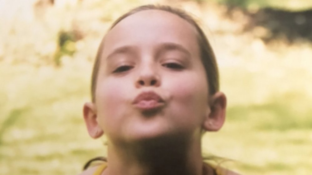 Dakota Johnson as a child making a kissy face