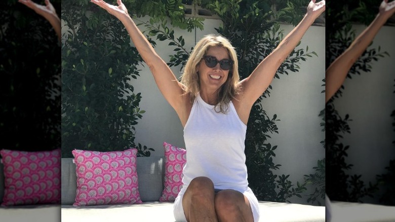 Denise Austin posing with arms raised