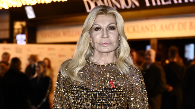 Donatella Versace posing at the premiere of The Devil Wears Prada: The Musical