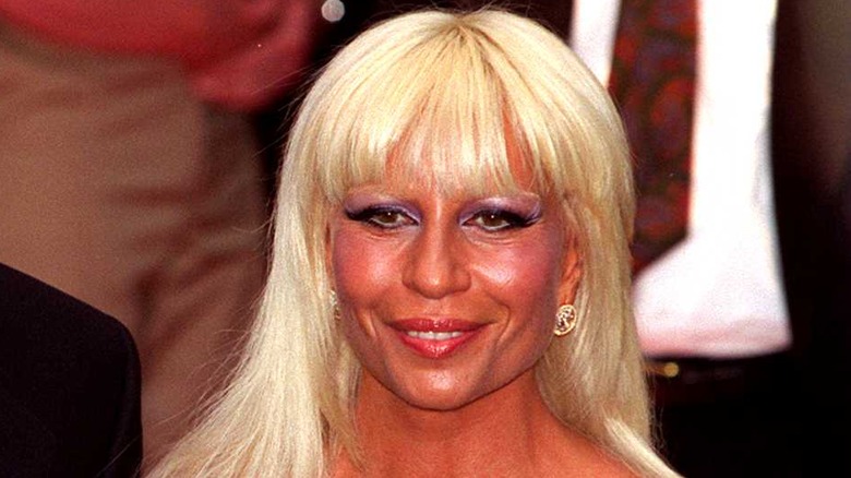 Donatella Versace smiling at a Versace party at Harrod's