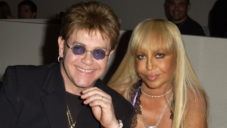 Elton John and Donatella Versace sitting together