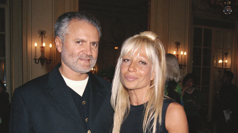 Gianni Versace and Donatella Versace posing at a Versace fashion show in Paris