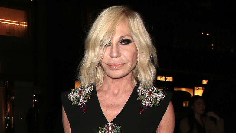 Donatella Versace frowning at the Versace boutique opening party in London