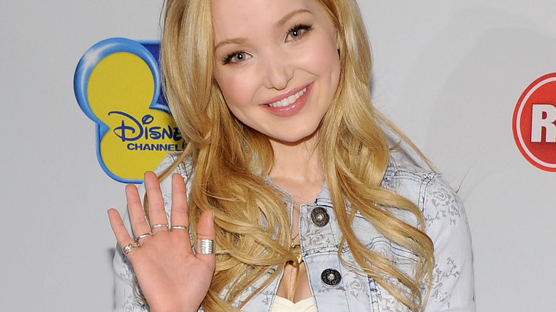 Dove Cameron waving at the camera