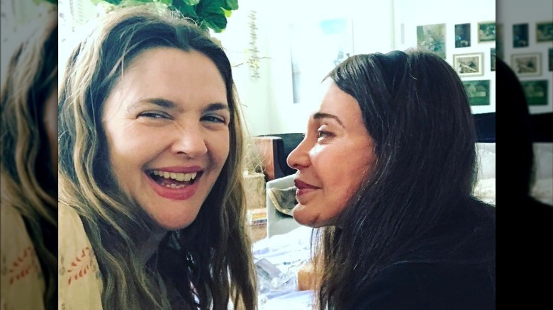 Drew Barrymore laughing next to her mother, Jaid