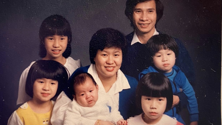 Young Linda Phan and her family posing for a photo